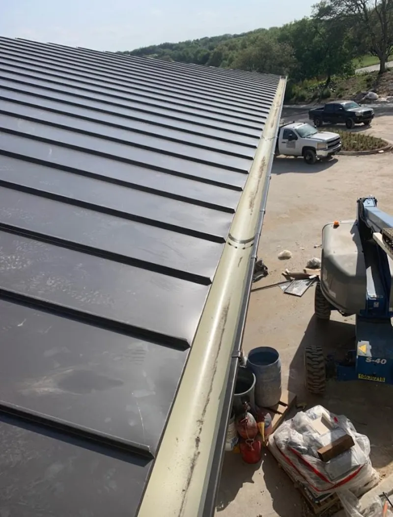 Standing seam panel and gutter detail on a metal roofing jobsite in North Auburn